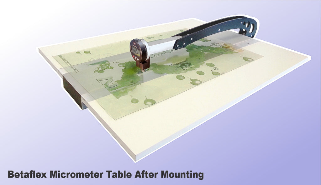 Betaflex Micrometer Table mounted between two tables, with a digital micrometer attached to it, prior to installation. Flexo plate measurement for depth and relief with with FlexoEye datadabase.  